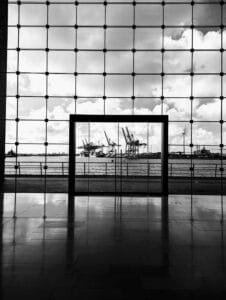 a black and white photo of a window with a view of a harbor